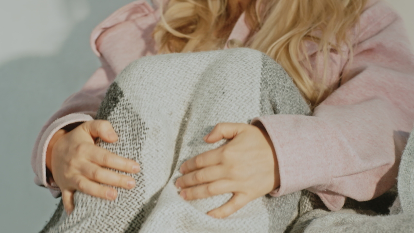 Beautiful Young Caucasian Girl Sitting in Her Room on Her Bed Looking Upset and Sad As She Is Cozied Up Under the Blanket. Depressed Young Girl Staying At Home Feeling Sad And Reminiscing .