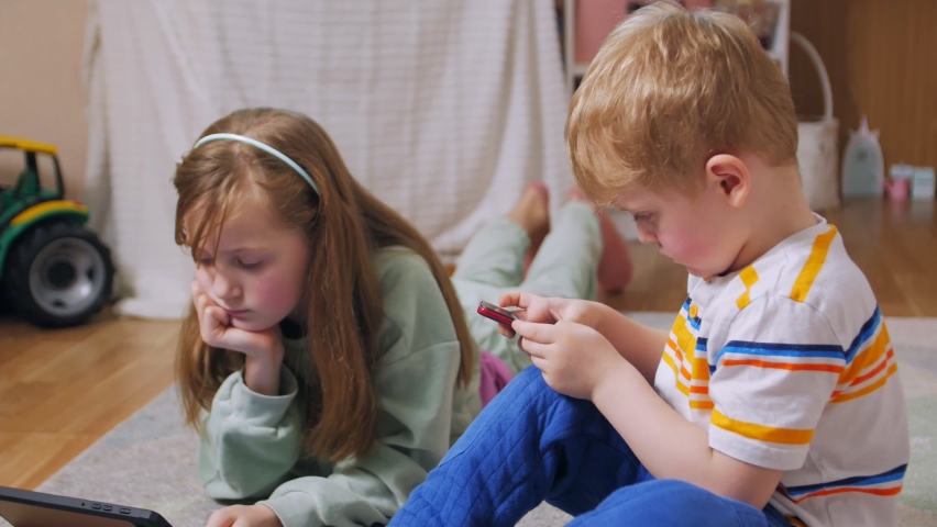 Girl and boy with phone and tablet refocusing