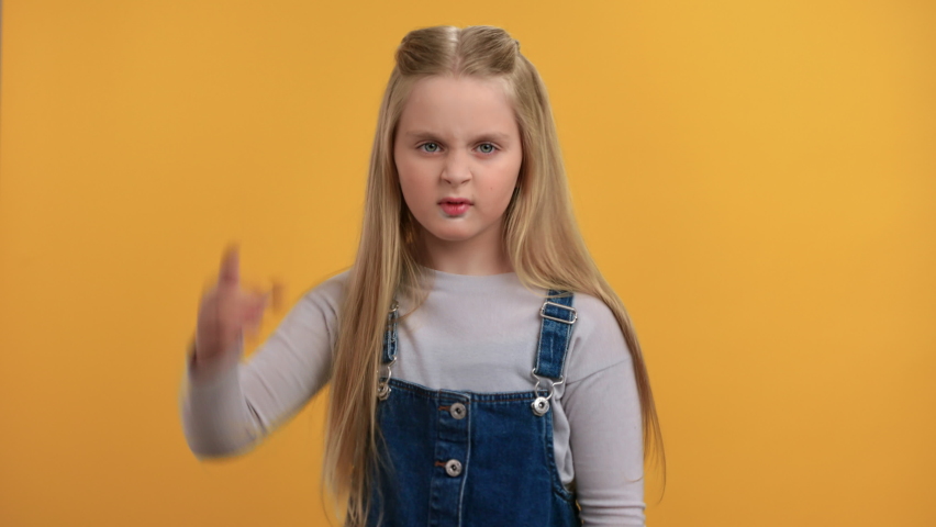 Portrait aggressive angry female kid shouting scolding with negative emotion posing isolated on orange studio. Irritated mad baby girl screaming having conflict annoyed displeased communication slowmo Royalty-Free Stock Footage #1086113819