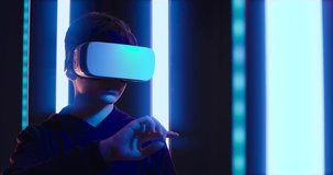 Teenager wearing VR glasses and experiencing immersive virtual reality, he is interacting with a virtual user interface - Powered by Shutterstock - Get 15% off with code: PIKWIZARD15