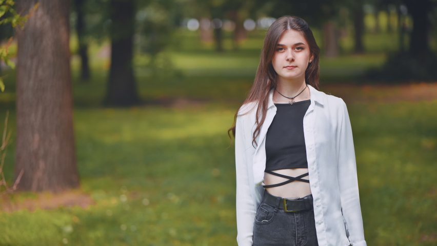 Portrait of a smiling young Georgian girl in a park.