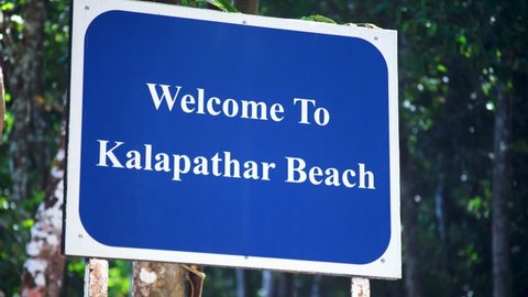 reveal establishing shot showing blue board with welcome to kalapathar beach a tourist spot and popular tourist destination in swaraj dweep havelock andaman and nicobar island india
