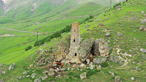 Aerial around view of medieval tower complex in the mountains of Ingushetia, Russia, 4k