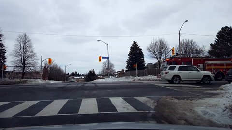 Toronto, Ontario, Canada - January 22nd, 2022. Driver Point of View Fire Emergency Vehicle Drives Past in Winter. Firefighter Engine Truck Passing By on the Road Street.