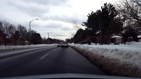 Toronto, Ontario, Canada - January 22nd, 2022. Driver Point of View Slowing Down and Stopping For Fire Emergency Vehicle in Winter. Drive Slow  and Stop on Road For Fire Truck Engine and Firefighters.