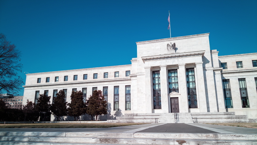 A daytime time-lapse of the Marriner S. Eccles Federal Reserve Board Building in Washington, D.C. on a sunny winter day. The camera pans from left to right. | Shutterstock HD Video #1086125477