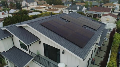 Contemporary House With Photovoltaic Solar System Installed On The Roof. drone pullback