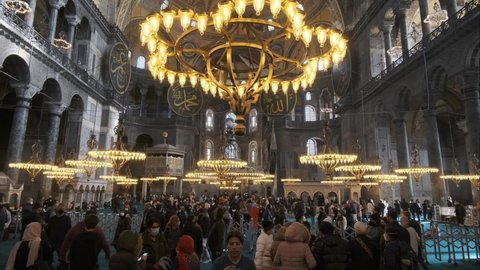 Istanbul , Turkey - 01 22 2022: Tourists vising Holy Hagia Sophia Grand Mosque