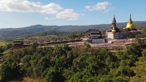 Aerial footage towards Wat Somdet Phu Ruea taken from the side revealing a construction going on, Ming Mueang, Loei in Thailand.