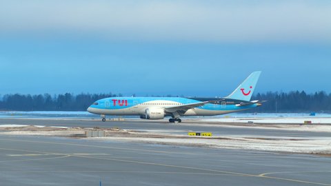 Oslo Airport Norway - January 27 2022: tui airways airplane boeing 787 taxiing in distance