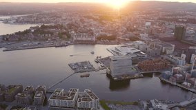 Inscription on video. Oslo, Norway. City view during sunset. Back light. The central part of the city. Oslo Opera. Shimmers in colors purple, Aerial View, Point of interest