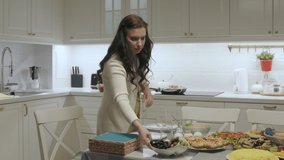 Family celebration dinner, woman setting the table for festive dinner in the kitchen. High quality 4k footage
