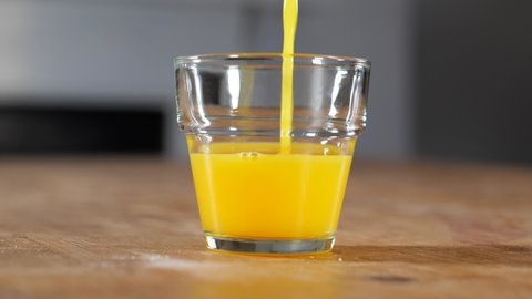 `Pouring orange juice into a glass