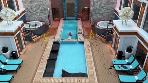 Orlando, FL USA - January 8, 2022:  Zooming in on the Haven Pool on the Norwegian Cruise Lines Haven cruise ship Escape in Port Canaveral, Florida.