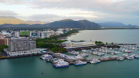 Aerial View Of Ferry Boats And Yachts Moored At Marina With Waterfront Hotel In Cairns, Australia.