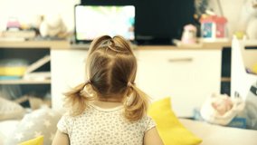 Happy Adorable Little Girl Watching Cartoon. Kids Leisure And Entertainment. Cute Children Watching Fairy Tale Story. Infant Baby Watching Television. Funny Children Enjoying Cartoons. Happy Childhood