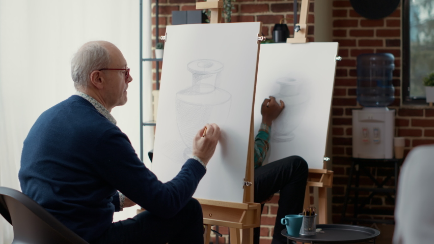 Old student using pencil to sketch vase model in creative workshop, drawing object to show artistic skills. New years resolutions to develop personal growth with art class. Handheld shot