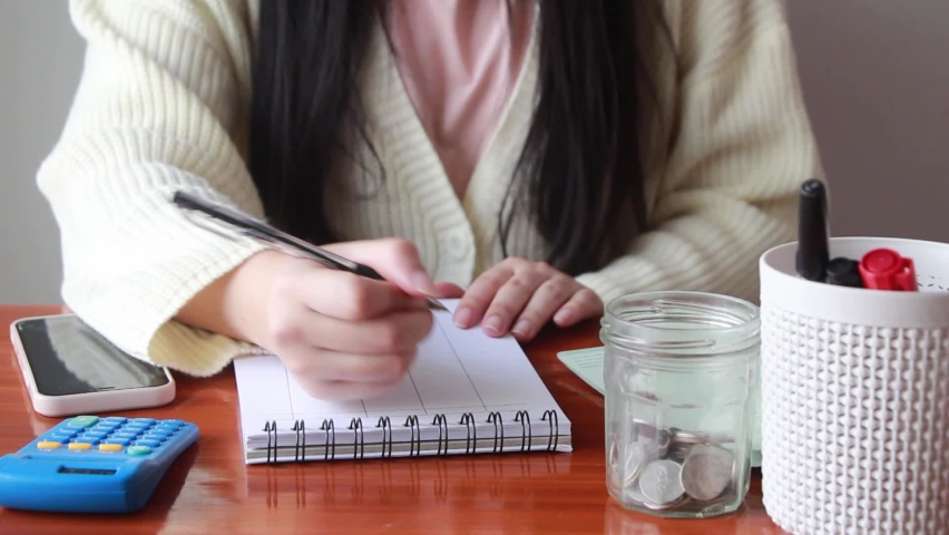 Young woman checking bills, tax, accounting for income and expenses.