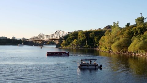 Ottawa, Canada - September 19, 2021: Ottawa River with ships and Alexandra Bridge to Gatineau city of Quebec, Canada