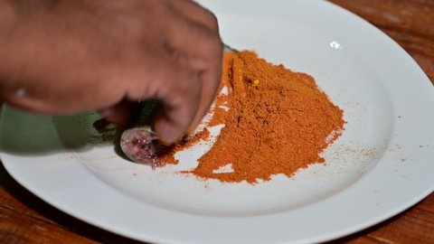  South Indian  spicy fish masala mixing for fish fry at the country side restaurant 