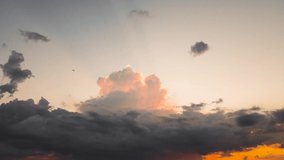 A panorama of a dark evening sky with beautiful gray clouds in the sunlight. Time lapse, dark skies at sunset. Weather, cloudy nature background. Video, footage for screensaver, transition, intro. 4K