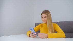 Happy white woman browsing internet on mobile phone. Smiling young adult female using modern smartphone for entertainment and communication online. Cheerful person using social media app on lockdown