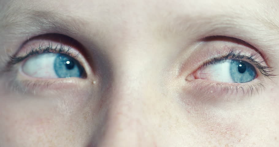Boy with blue eyes looks suspiciously from side to side and then stares wide-eyed at the camera, as if shocked or frightened.