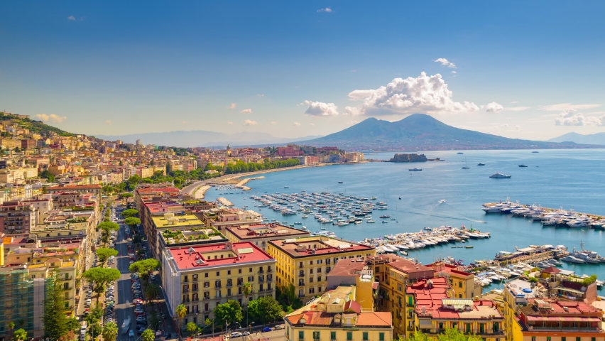 Naples, Italy. August 31, 2021. View of the Gulf of Naples from the Posillipo hill with Mount Vesuvius far in the background Boats come in and out to the marina. Time lapse video with panning effect. Royalty-Free Stock Footage #1086180053