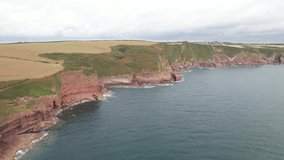 Stunning landscape scenery. Rugged rocks on sea coast. Slide and pan footage of Greenala Point peninsula. South Wales, UK