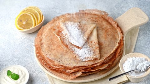 English-style pancakes with lemon and sugar, traditional for Shrove Tuesday. Powdered sugar with lemon juice on pancake. English pancake day holiday