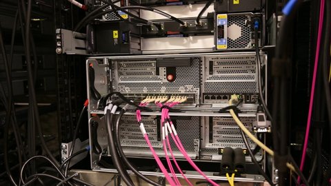 Hamburg, Germany - January 21, 2022: Fiber optic network connections on a HP server blade system enclosure in a data center
