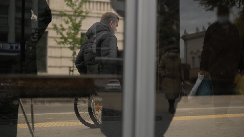 Person with a physical disability waiting for city transport with an accessible ramp Royalty-Free Stock Footage #1086188471