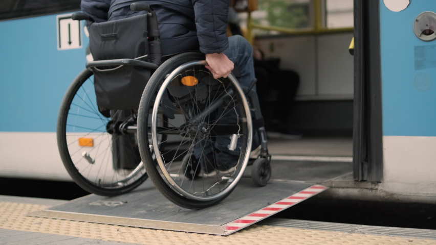 Person with a physical disability enters public transport with an accessible ramp Royalty-Free Stock Footage #1086188528