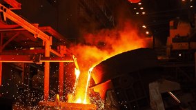metallurgical plant, hot metal. pouring bright hot liquid steel from ladle in blast furnace foundry metallurgical factory. steel smelting process with bright sparks and smoke - Powered by Shutterstock - Get 15% off with code: PIKWIZARD15