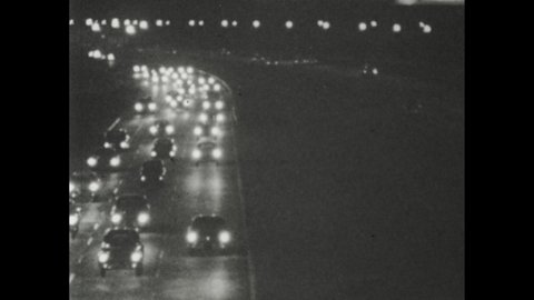 1950s: Modern divided multi-lane highway with overpasses. Four-lane highway divided by meridian with busy traffic. Busy highway at night with headlights. Parked cars with people standing by accident.