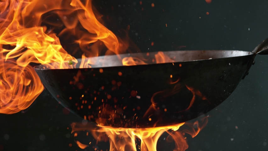 Super Slow Motion Shot of Wok Pan with Flying Ingredients in the Air and Fire Flames. Filmed on High Speed Cinema Camera at 1000 FPS. | Shutterstock HD Video #1086192224