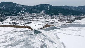 Flying with a drone above the frozen lake Golcuk at Bozdag Odemis Izmir Turkey in winter season.