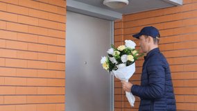 Woman opening entrance door and receiving flowers from courier. Medium shot of happy mature woman receiving bouquet of flowers for birthday, signing for delivery. Celebration, delivery concept - Powered by Shutterstock - Get 15% off with code: PIKWIZARD15