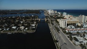 Cars driving along A1A in Hollywood Florida. Ocean and Intracoastal aerial views. 4K Drone Video.