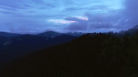 Great mountain range with colorful cloud from a bird's eye view. Location place Carpathian mountains, Ukraine, Europe. Aerial footage, cinematic drone shot. Filmed in UHD 4k video. Beauty of earth.
