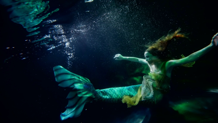 mysterious underwater world, magical mermaid is floating in depth, art and fantasy shot Royalty-Free Stock Footage #1086205304
