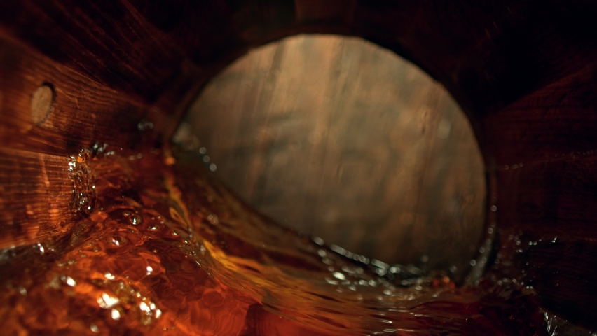 Super Slow Motion Detail Shot of Waving Whiskey in Wooden Barrel at 1000fps. Royalty-Free Stock Footage #1086205757