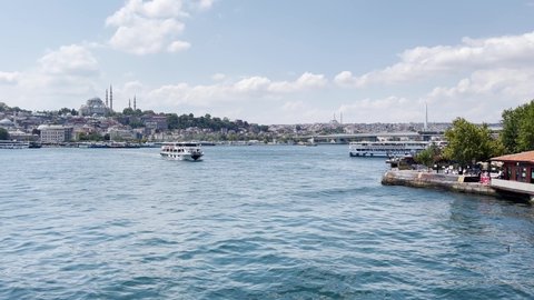 Istanbul, Turkey - August 22, 2021; Many ferryboats sail on the Bosphorus river with Galata Bridge in the background in Istanbul