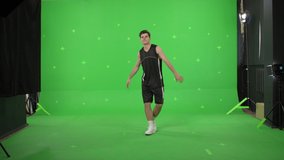 basketball player wearing sports clothes dancing on green screen background, Chroma Key. 4K UHD graded footage