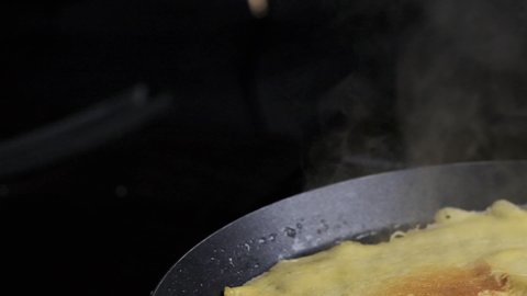Steaming French pancake  baking pano right on black background  slow motion