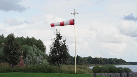 red and white flag. Wind designator - a device to indicate the direction of the wind on helipads, airfields, oil and gas producing enterprises, ranges and shooting ranges.