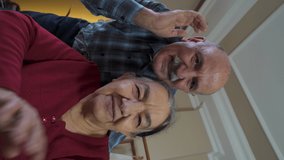 Vertical video of Portrait of lovely old couple enjoying online video call talking laughing looking at camera.  senior woman is using smart phone for communicate and make video chat with her children - Powered by Shutterstock - Get 15% off with code: PIKWIZARD15