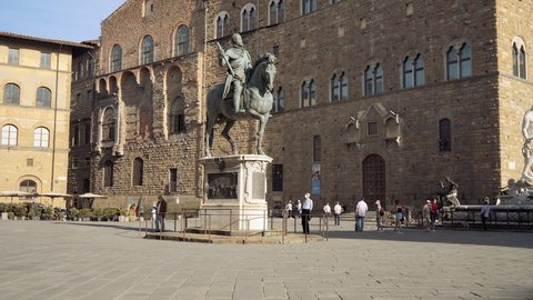 Florence, Italy - June 04, 2021: panning of tourists in front of Palazzo Vecchio, in Piazza della Signoria, Firenze