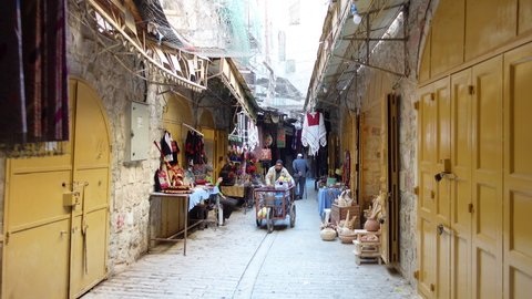 HEBRON, WEST BANK – NOVEMBER 7 2021: Walking through historic bazaar in central Hebron, a contentious area claimed by both Israeli settlers and local Palestinians

