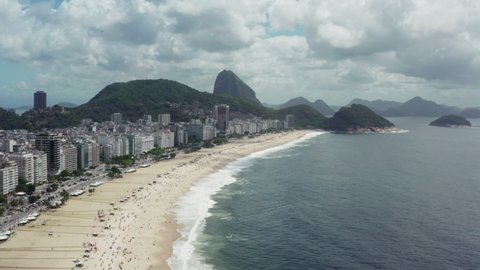 Aerial view of Rio de Janeiro beach. Copacabana beach in downtown on the Atlantic Ocean and beautiful mountain landscape.